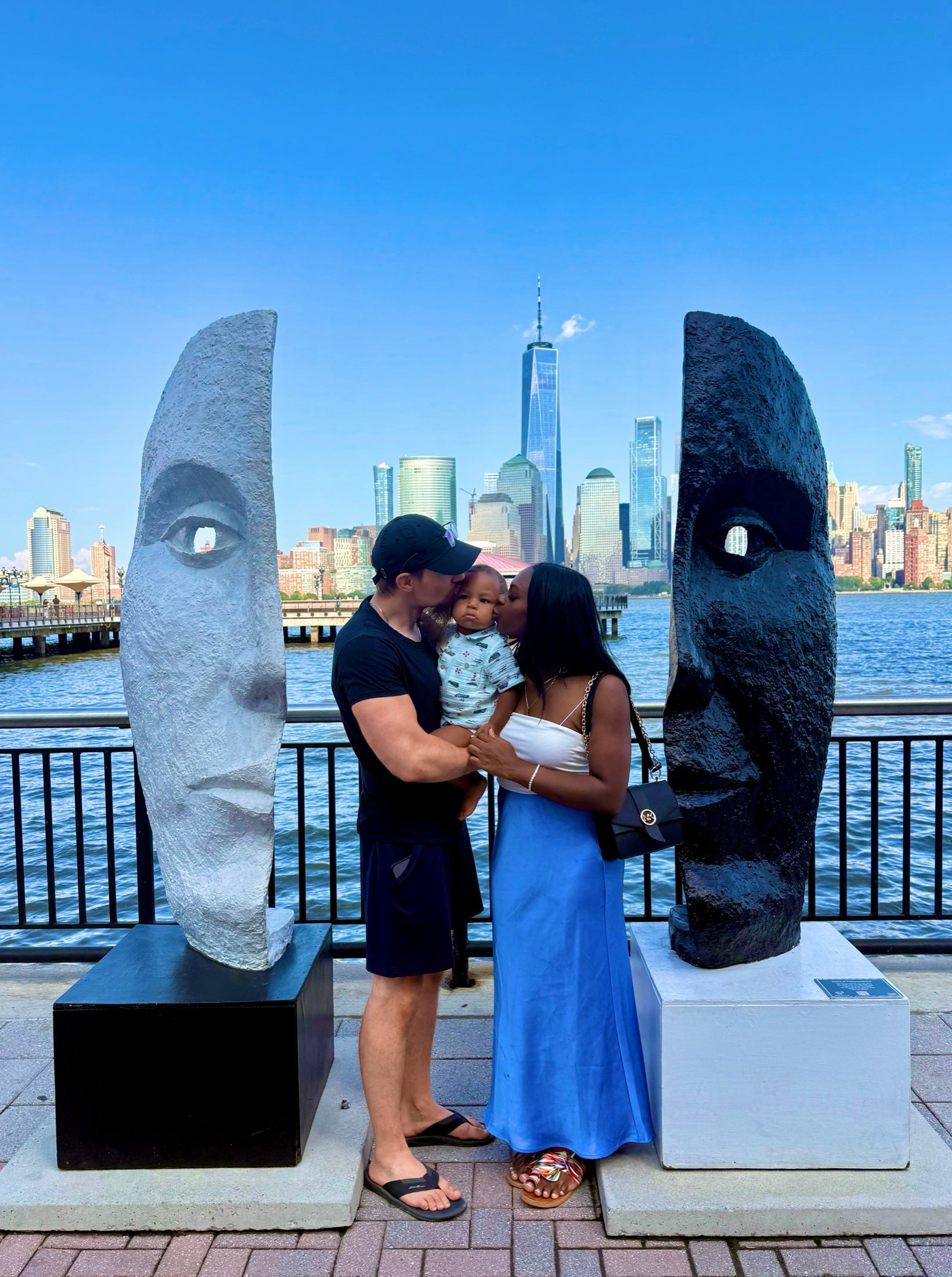 Dawid and Ayanna with their son by the waterfront